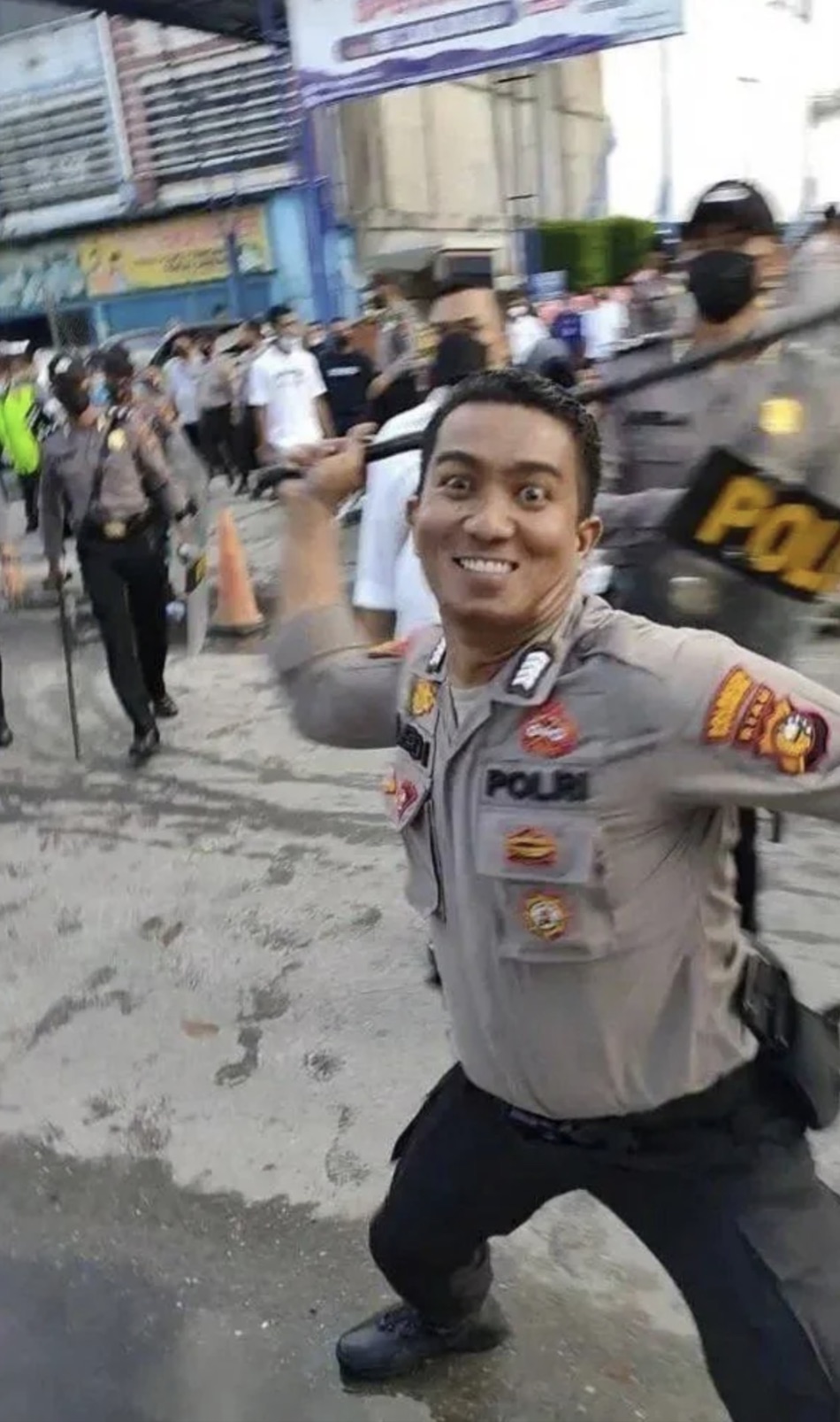 smiling cop with baton